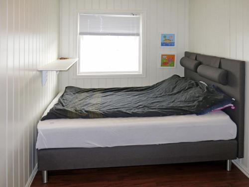 a bed in a room with a window at Holiday Home Villa Syltebær by Interhome in Kyrkjebø