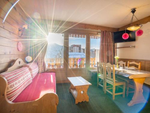 un salon avec un canapé, une table et une fenêtre dans l'établissement Apartment Névés 20 by Interhome, à Val Thorens