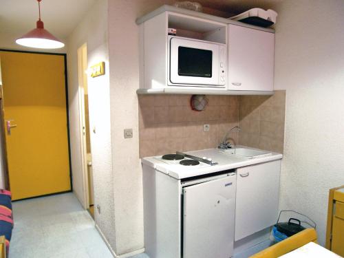 a small kitchen with a sink and a microwave at Apartment Les Olympiques - Tignes 1800-7 by Interhome in Les Boisses