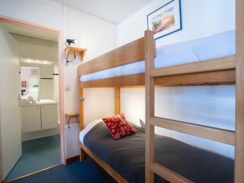 a bedroom with two bunk beds and a bathroom at Apartment Le Curling B-20 by Interhome in Tignes