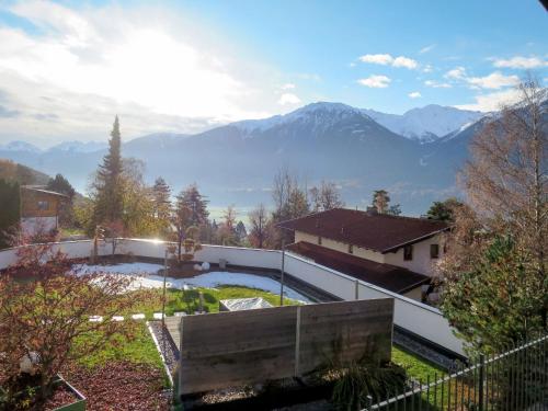 a backyard with a pool and mountains in the background at Holiday Home Waldruh - SFE300 by Interhome in Telfs