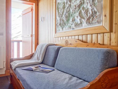 a bedroom with a bed with a book on it at Apartment La Divaria by Interhome in Tignes