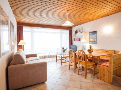 sala de estar con sofá, mesa y sillas en Apartment Essert 308 by Interhome, en Les Collons
