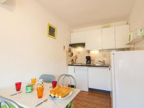 a kitchen with a table with a plate of food on it at Apartment La Croix du Sud-4 by Interhome in Cavalaire-sur-Mer