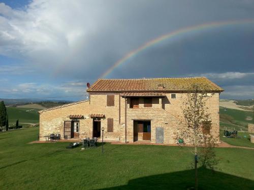 a rainbow over a house with a green field at Apartment A1 by Interhome in Casetta