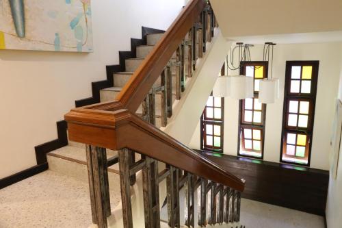 a staircase in a home with wooden railings at Kampaeng Ngam Hotel in Chiang Mai