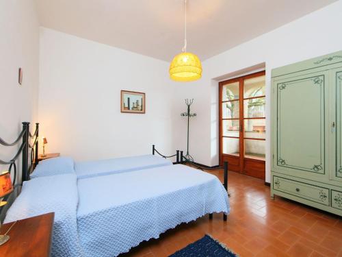 a bedroom with a blue bed and a greenoire at Holiday Home Montebello by Interhome in Monterchi