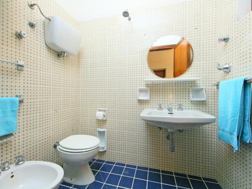 a bathroom with a toilet and a sink and a mirror at Holiday Home Montebello by Interhome in Monterchi
