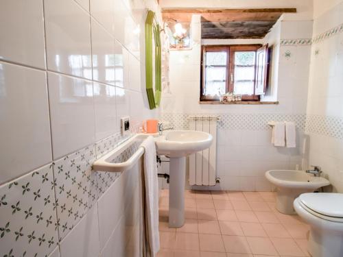 a bathroom with a sink and a toilet at Holiday Home Poggio Velluto by Interhome in Seggiano