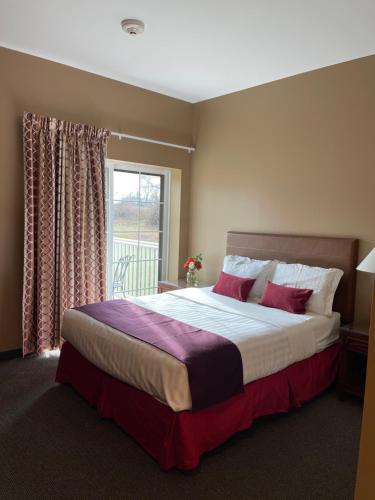 a bedroom with a large bed with a window at Brinton Suites in West Chester