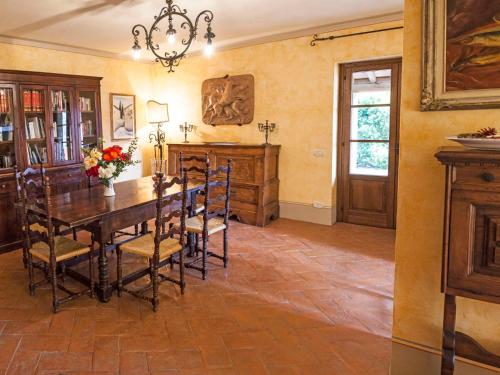 a dining room with a wooden table and chairs at Apartment Allerona-3 by Interhome in Allerona