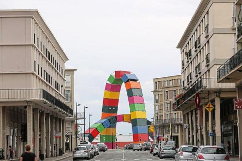 a large colorful kite flying over a city street at Villa Raphaëlle #4 Centre ville avec parking in Le Havre
