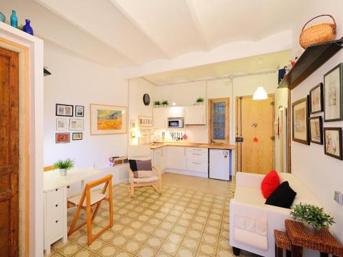 a kitchen and living room with a table and chairs at Apartment Eixample Dret Valencia - Cartagena by Interhome in Barcelona