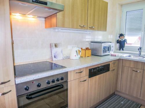 a kitchen with a sink and a stove top oven at Holiday Home Stefanie by Interhome in Mühldorf