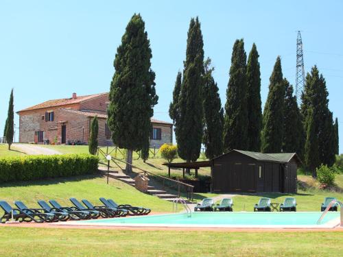 a group of chairs sitting around a swimming pool at Apartment B1 by Interhome in Casetta