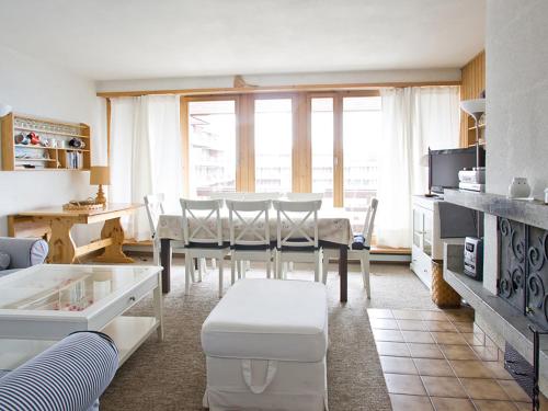 a living room with a dining table and a kitchen at Apartment Arzinol 402 by Interhome in Les Collons