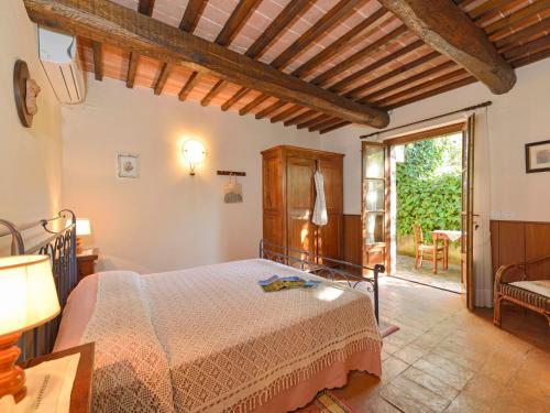 a bedroom with a bed and a door to a patio at Holiday Home Malagronda-1 by Interhome in Ravigliano