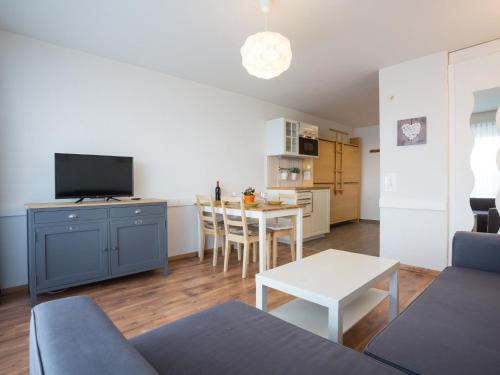 a living room with a couch and a table at Studio Greppon 107 by Interhome in Les Collons