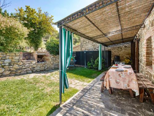 a patio with a table and an umbrella at Holiday Home Casa Graziani-5 by Interhome in Ravigliano
