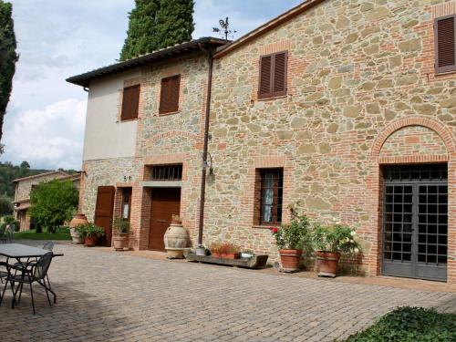 a stone building with a table and chairs in front of it at Holiday Home Casa Graziani-5 by Interhome in Ravigliano