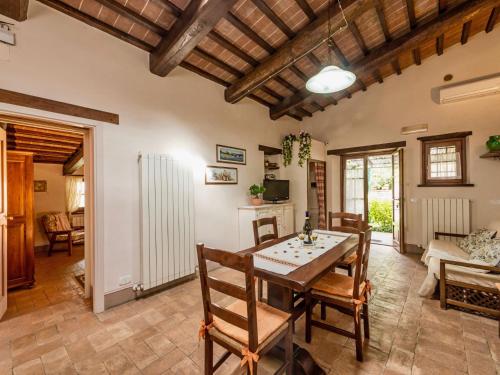 a living room with a wooden table and chairs at Holiday Home Casa Graziani-5 by Interhome in Ravigliano