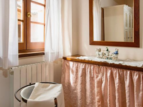 a table with a mirror and a chair in a room at Holiday Home Casa Graziani-5 by Interhome in Ravigliano