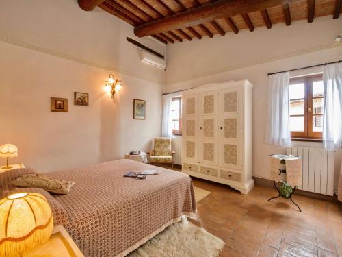 a bedroom with a bed and a chair in it at Holiday Home Casa Graziani-5 by Interhome in Ravigliano