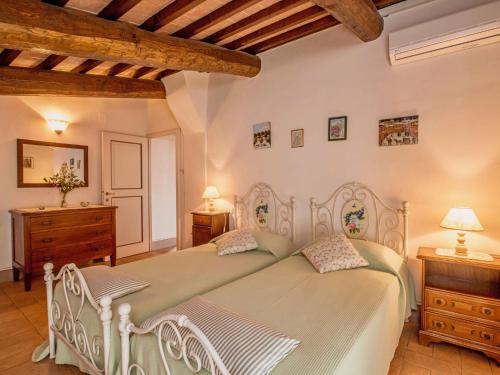 a bedroom with a white bed and two night stands at Holiday Home Casa Graziani-5 by Interhome in Ravigliano