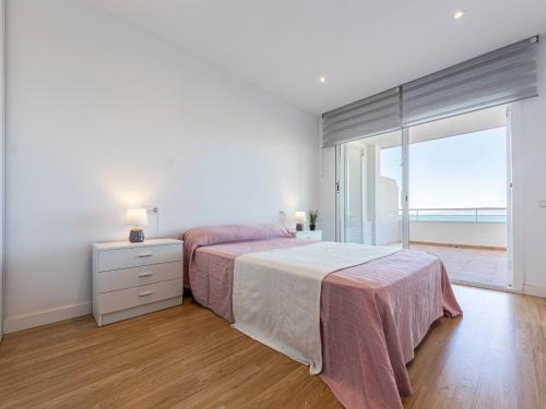 a bedroom with a bed and a dresser and a window at Apartment Rits-1 by Interhome in Salou