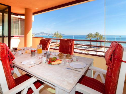 a dining room with a table with a view of the ocean at Apartment Zafiro 01 by Interhome in Calpe