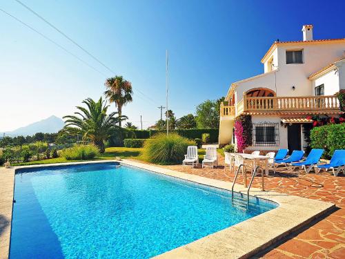 a swimming pool in front of a house at Holiday Home Portichol by Interhome in Balcon del Mar