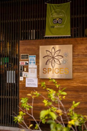 a door of a store with signs on it at Spices Hotel in George Town