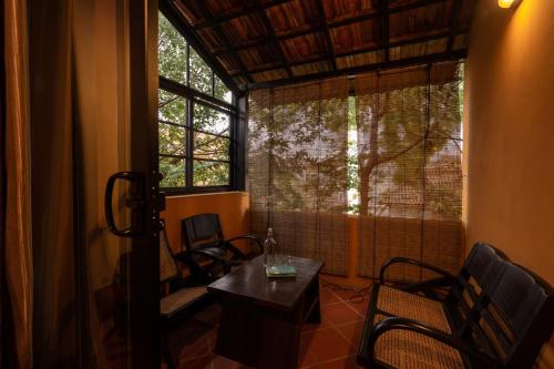 a room with chairs and a table and a window at Spices Hotel in George Town