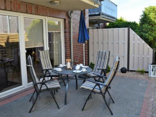 a table and chairs sitting on a patio at Apartment Seestern by Interhome in Norddeich