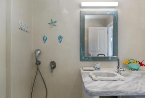 a bathroom with a sink and a mirror at Magganari View Village in Manganari