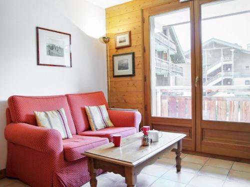 a living room with two chairs and a coffee table at Apartment Les Capucins by Interhome in Chamonix