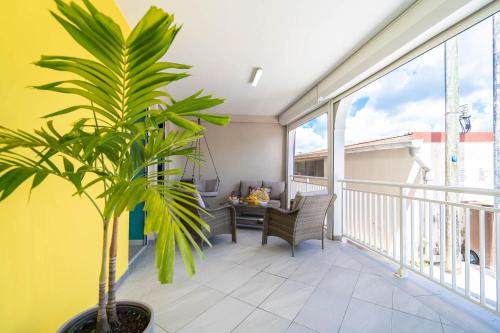 a balcony with a table and a plant on it at Villa Perle Dor in Sainte-Anne