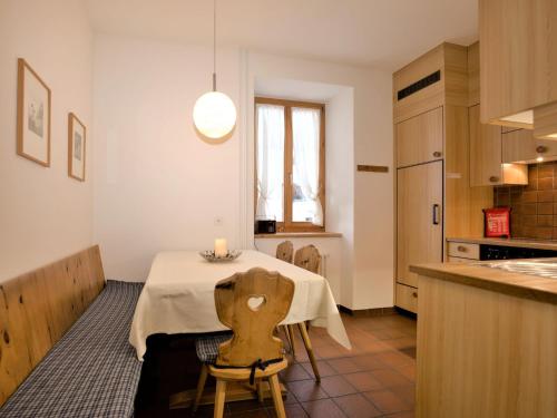 a kitchen with a table with a white table cloth at Apartment Chesa Corvatsch by Interhome in Pontresina