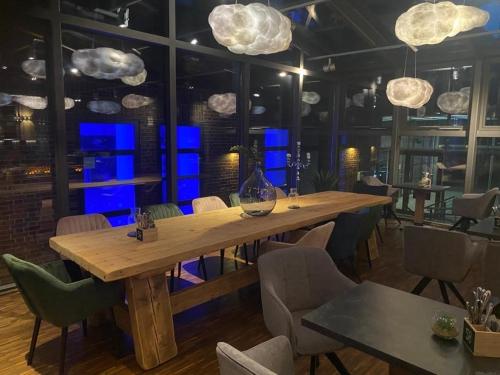 a dining room with a wooden table and chairs at Heiner's Parkhotel in Gelsenkirchen