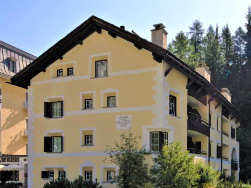 a large yellow building with a roof at Apartment Chesa Alvetern 5 by Interhome in Sils Maria