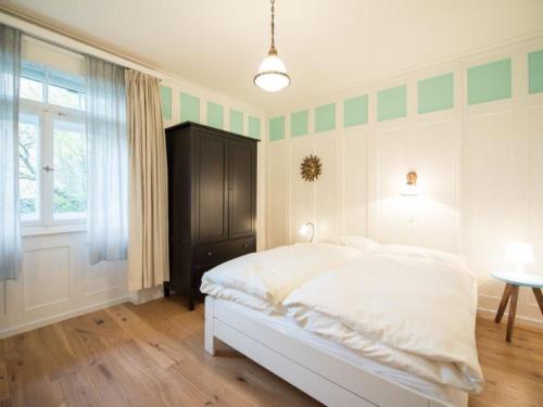 a bedroom with a white bed and a window at Apartment Haus Altein Apartment Nr- 4 by Interhome in Davos