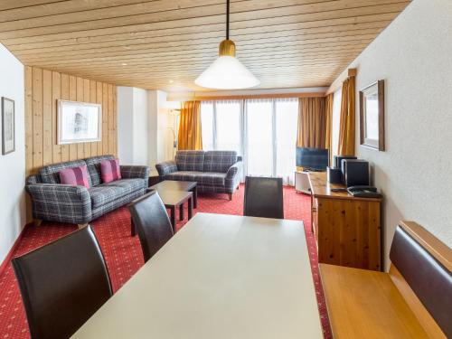 a living room with a table and chairs at Apartment Chalet Abendrot apARTments-26 by Interhome in Grindelwald