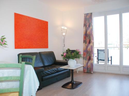 a living room with a couch and a table at Apartment Residenza Corallo-7 by Interhome in Ascona