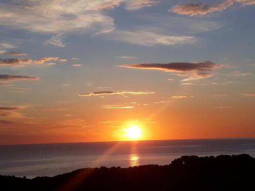 a sunset over the ocean with the sun in the sky at Apartment Melis-II - 5 by Interhome in Pals