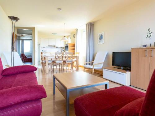 a living room with a couch and a table at Apartment Ferienwohnpark Immenstaad-1 by Interhome in Immenstaad am Bodensee