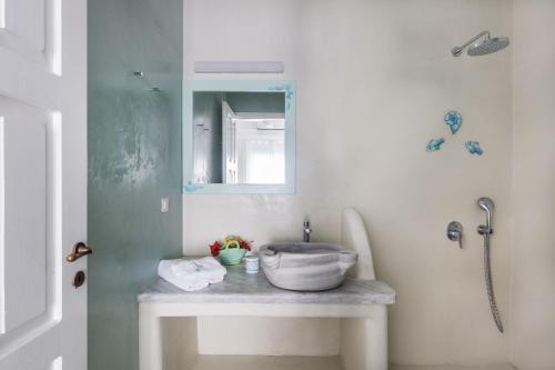 a bathroom with a sink and a mirror at Magganari View Village in Manganari