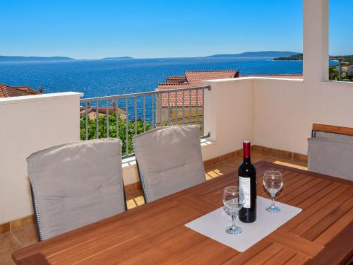 a bottle of wine sitting on a table on a balcony at Apartment Lucija-1 by Interhome in Trogir