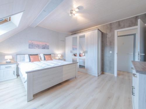 a bedroom with a large white bed in a room at Apartment Derby by Interhome in Mispelburg