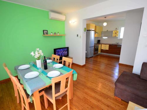 a dining table and chairs in a living room at Apartment Cvita-1 by Interhome in Sovlje