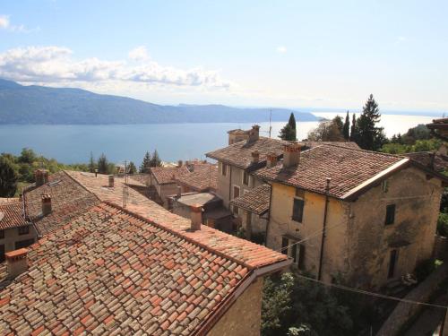 a view of a town with roofs and a lake at Apartment Formaga-2 by Interhome in Gargnano